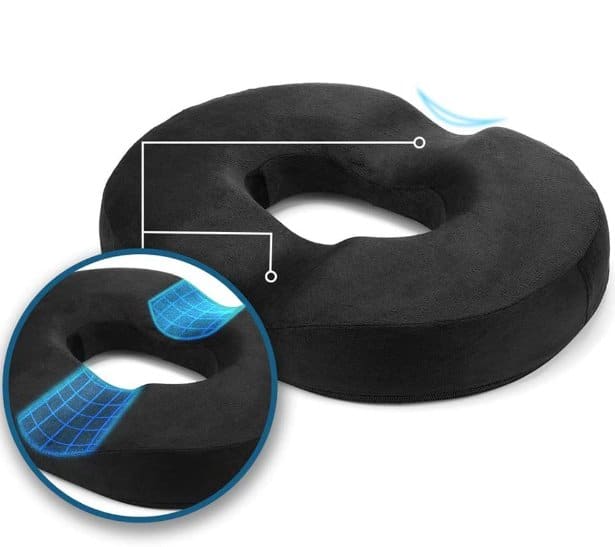 A black orthopedic donut cushion whose indentations are clarified 