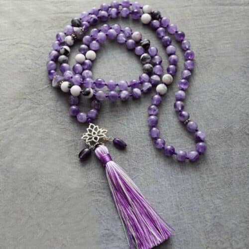 an image of Amethyst Energy Spiritual Lotus Meditation Necklace laying in a rough surface