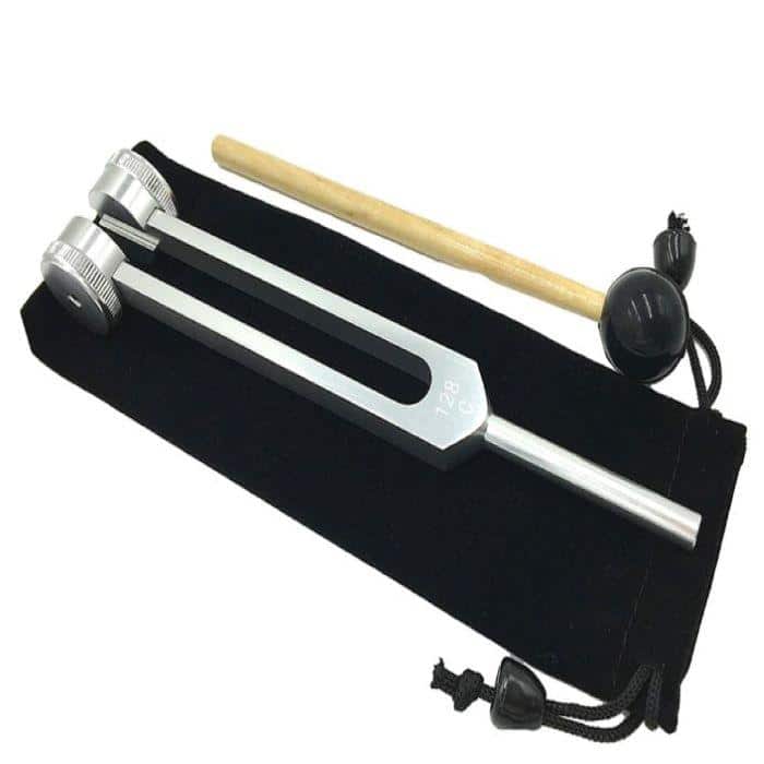 A silver meditation tuning fork with a bag and mallet