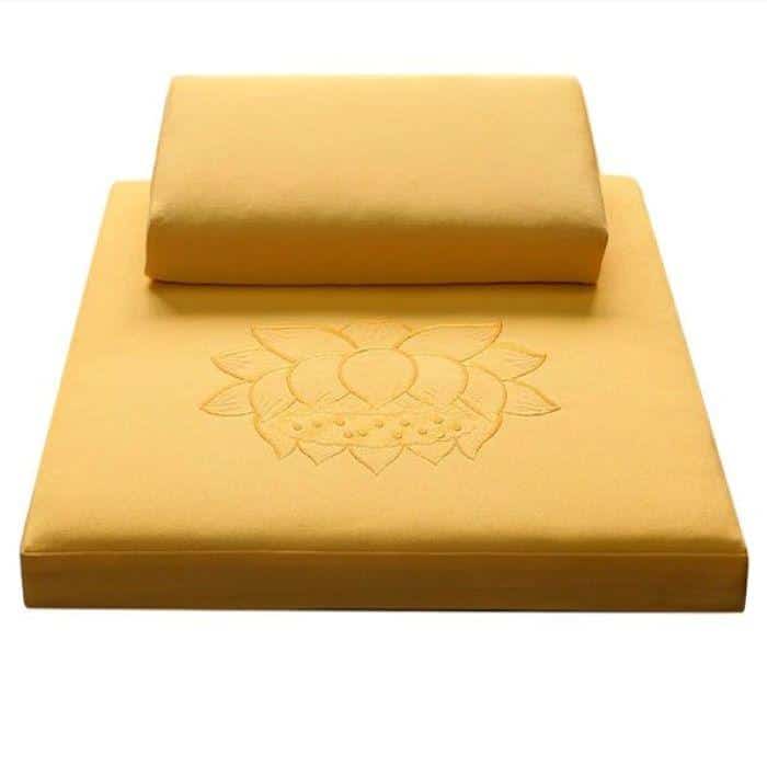A yellow zafu and zabuton meditation gift set with a lotus design