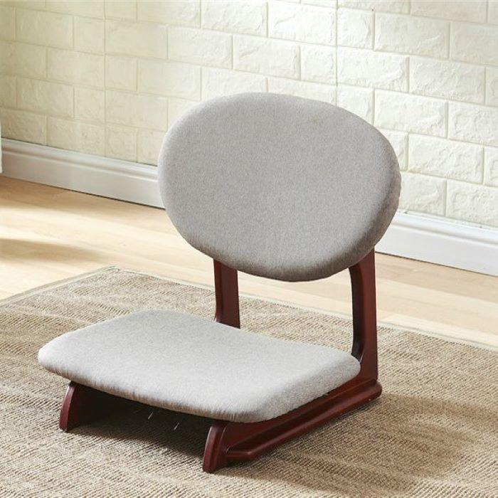 A brown wooden legless chair with a gray back and seat cushioning