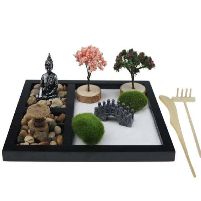 Mindfulness meditation gift: A well-decorated miniature Zen garden with white sand and a tiny wooden rake and stylus