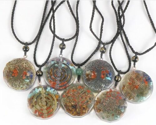 different kinds of Energy Generator Orgone Amulet Meditation Necklace on a white background