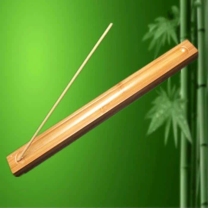 A bamboo meditation incense holder with green background