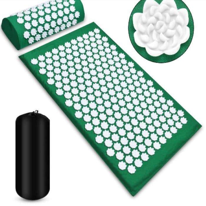 A green shakti acupressure and meditation bed with white spikes and bag. 