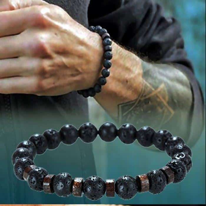 A picture of two black lava meditation bracelets as one of the best meditation gifts, one worn on a man’s wrist